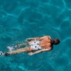 overhead shot of a woman swimming in a pool