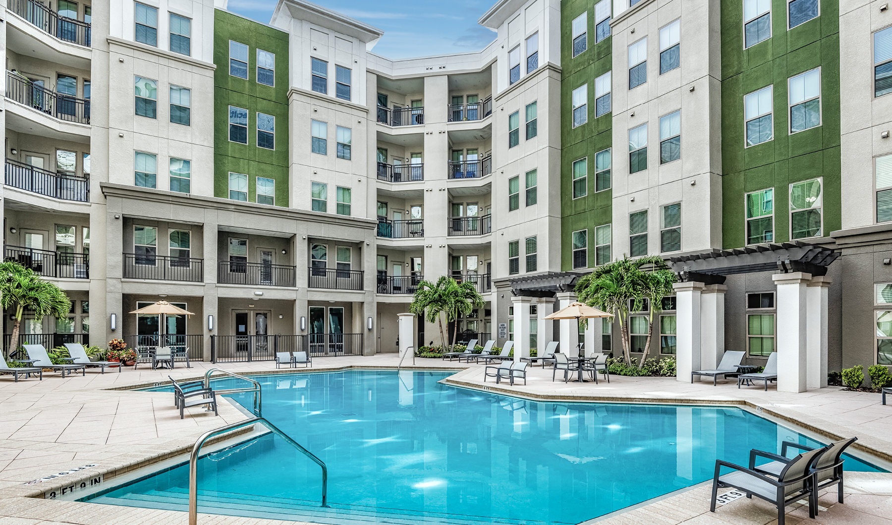 Resort-style swimming pool with lounge seating