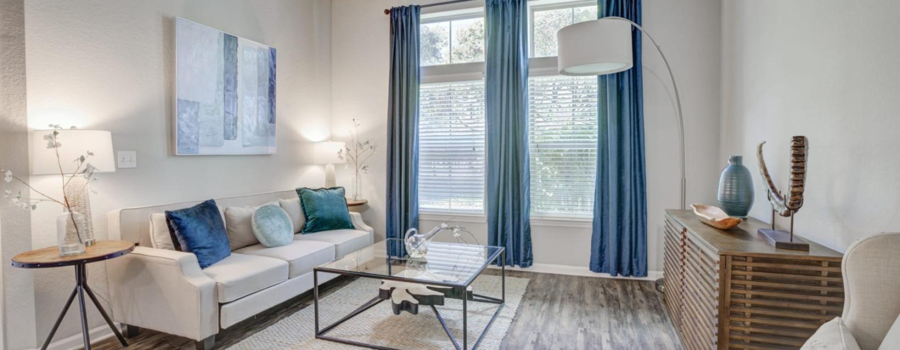 a living room with a white couch and a table